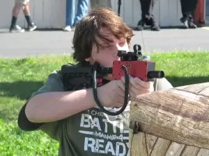 A man holding a laser tag tagger.