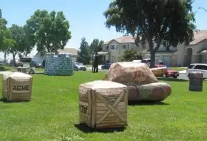 A group of laser tag barriers set up for a party in a grassy area.