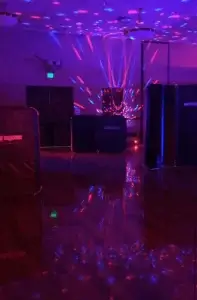 A room with laser tag barriers and purple lights at a laser tag night party.